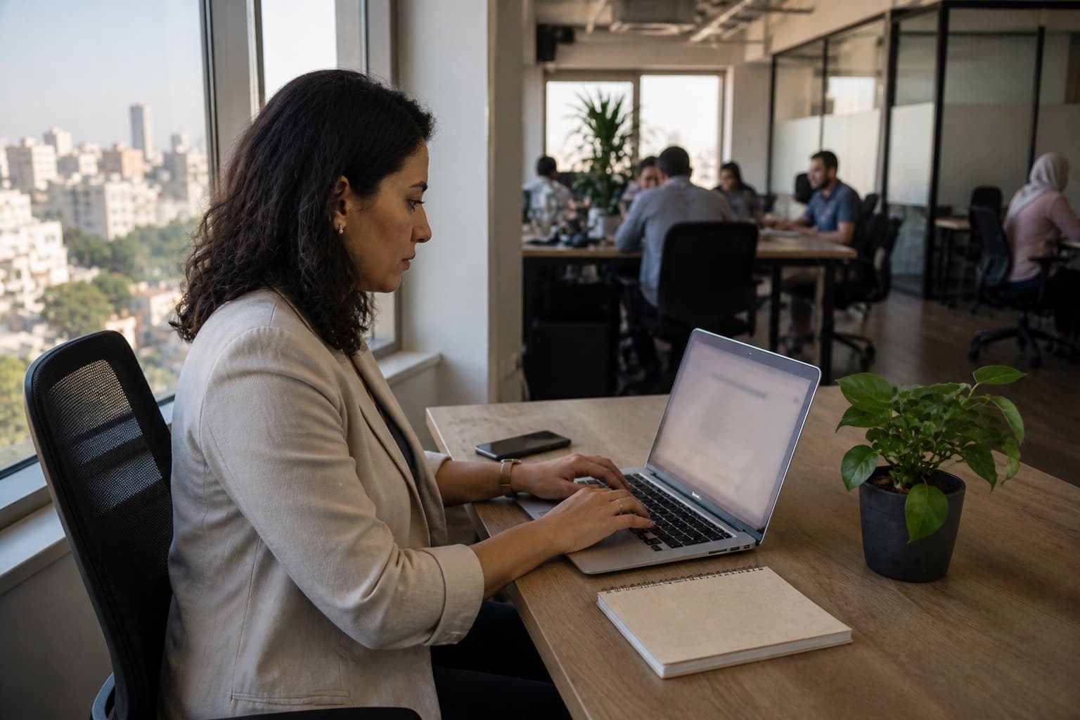 A recruiter setting up a role on a laptop in a bright office